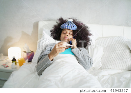 Woman With Fever Using Thermometer And Calling Doctor By Phone 41943237