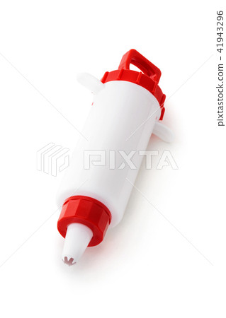 Confectionery syringe on white. 41943296