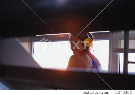 Young Woman Listening To Music With Wireless Earphones Young Woman Listening To Music With Wireless Earphones 41943366