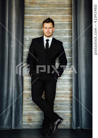 Stylish athletic ofiice man in a business owner costume vest. background of a interior cafe loft. 41943460