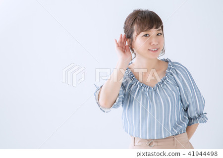 A woman listening to something A woman listening to something 41944498