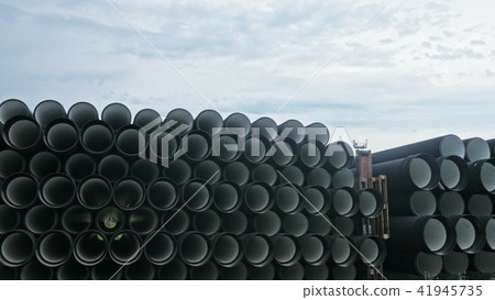 Warehouse of finished plastic pipes industrial outdoors storage site. Manufacture of plastic water Warehouse of finished plastic pipes industrial outdoors storage site. Manufacture of plastic water 41945735