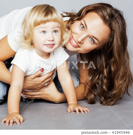 young modern smiling blond mother with little cute daughter on w 41945946