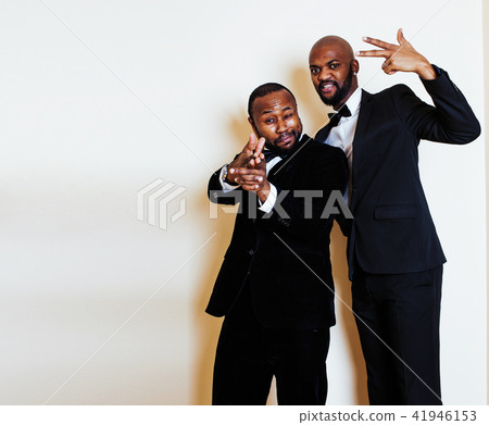 two afro-american businessmen in black suits emotional posing, g 41946153