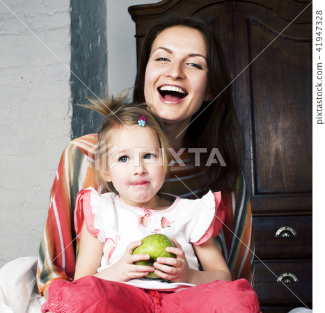 mother with daughter together in bed smiling, happy family close mother with daughter together in bed smiling, happy family close 41947328