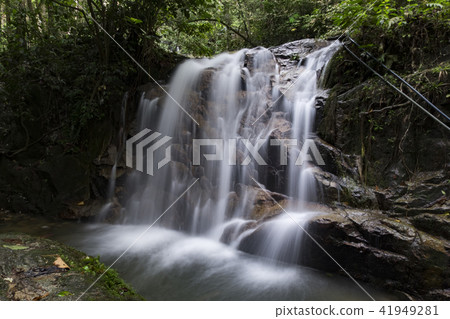 Beautiful cascading tropical waterfall in lush  41949281