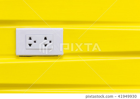 White electric plugs on modern yellow wallpaper. White electric plugs on modern yellow wallpaper. 41949930