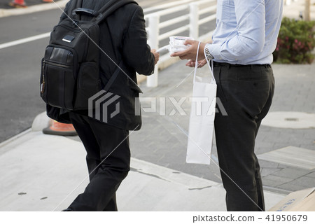 Men distributing tissues Men distributing tissues 41950679