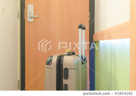 travel suitcase in a hotel room by arrival 41954292