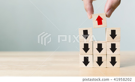 Hand picked wooden block with red arrow 41958202