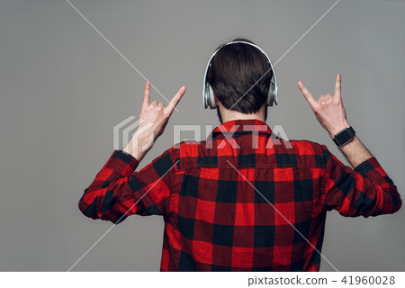 Back View. Man Listening to Music with Headphones 41960028