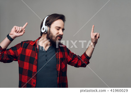 Happy Guy Listening to Music with Headphones Happy Guy Listening to Music with Headphones 41960029