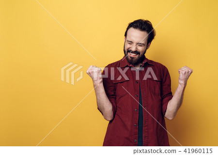 Portrait of Happy Bearded Man Clenching Fists Portrait of Happy Bearded Man Clenching Fists 41960115