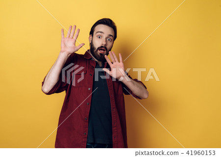 Portrait of Shocked Bearded Man keeps Hands up Portrait of Shocked Bearded Man keeps Hands up 41960153