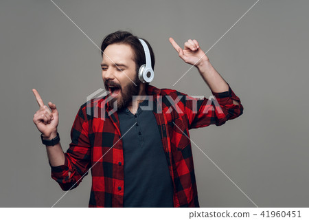 Happy Young Man Listening to Music with Headphones Happy Young Man Listening to Music with Headphones 41960451