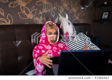 Surprised young woman is lying on the bed with funny boyfriend Surprised young woman is lying on the bed with funny boyfriend 41960467