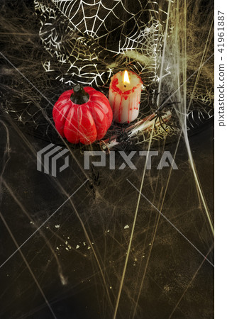 Pumpkin, candle and a long glass with a red cocktail Pumpkin, candle and a long glass with a red cocktail 41961887
