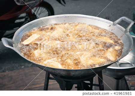 frying food in hot oil deep fried boiling food oil 41961981