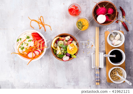 Salad making. Cutlery and dressing ingredients for fresh salad on stone gray background, top view 41962121