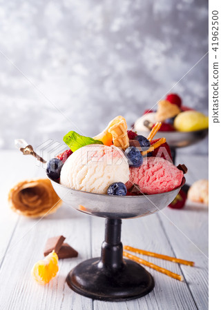 Homemade Organic Vanilla Ice Cream with Mint and ice berries on wooden background 41962500