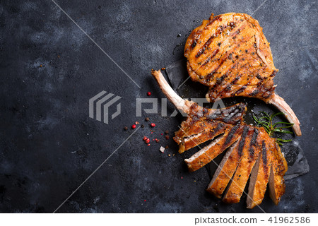 Grilled T-bone steak on stone table. Top view with copy space Grilled T-bone steak on stone table. Top view with copy space 41962586