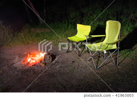 Green chairs near bonfire at night Green chairs near bonfire at night 41963003