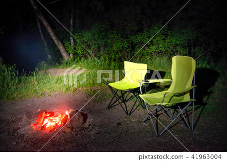 Green chairs near bonfire at night Green chairs near bonfire at night 41963004