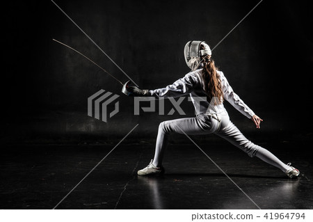 Female fencer isolated on black background Female fencer isolated on black background 41964794