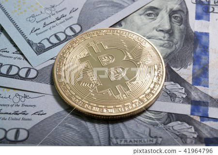 golden bitcoin coin on us dollars close up golden bitcoin coin on us dollars close up 41964796