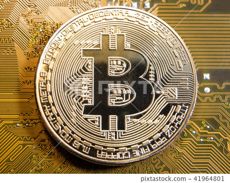golden bitcoin coin on golden microchip close up golden bitcoin coin on golden microchip close up 41964801