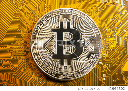 golden bitcoin coin on golden microchip close up 41964802