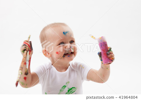 Cute little baby painting with paintbrush and colorful paints on white background Cute little baby painting with paintbrush and colorful paints on white background 41964804