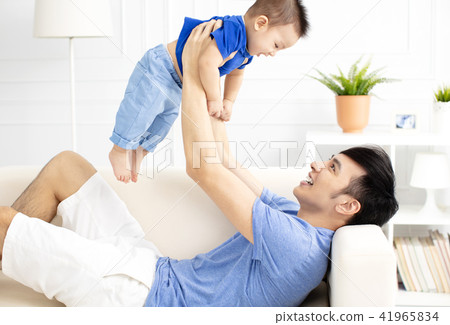 Father And Son Playing On Sofa Father And Son Playing On Sofa 41965834