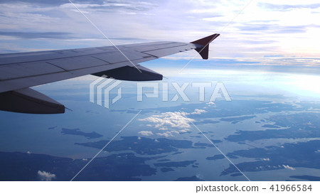 Wing of an airplane flying above the clouds with sunset sky. Aircraft. Wing of an airplane flying above the clouds with sunset sky. Aircraft. 41966584
