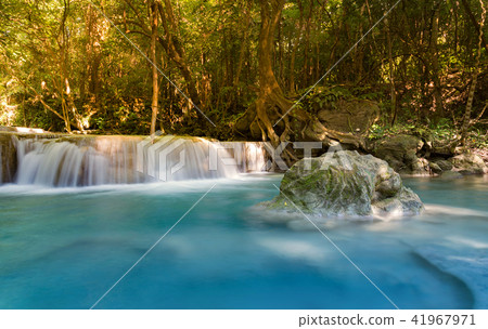 Blue stream waterfall in deep tropical forest 41967971