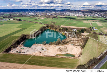 Aerial drone view of open pit dredging lake in a abandoned gravel mine Aerial drone view of open pit dredging lake in a abandoned gravel mine 41968667