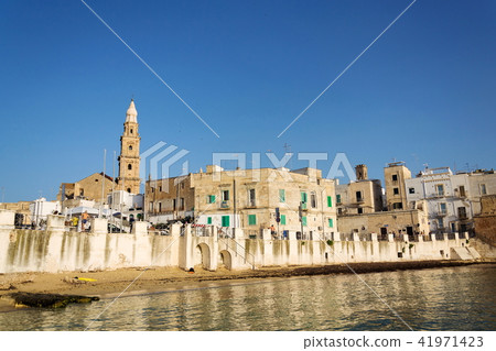 Sunrise on beach near Cathedral in Monopoli, Italy Sunrise on beach near Cathedral in Monopoli, Italy 41971423