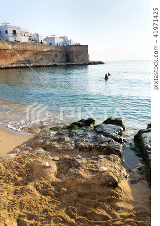 Sunrise on beach near Cathedral in Monopoli, Italy Sunrise on beach near Cathedral in Monopoli, Italy 41971425