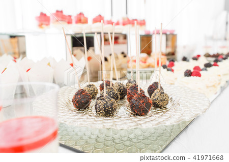 Candy bar with a lot of desserts, meringue, cupcake, fruit and sweet cakes. Sweet table for birthday Candy bar with a lot of desserts, meringue, cupcake, fruit and sweet cakes. Sweet table for birthday 41971668
