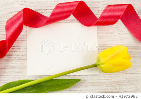 Empty postcard with flower and red ribbon 41972968