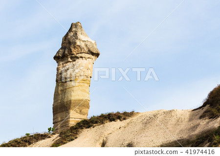 fairy chimney rock on mountain slope in Goreme 41974416