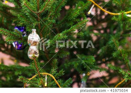 old glass toy on natural christmas tree indoor 41975034