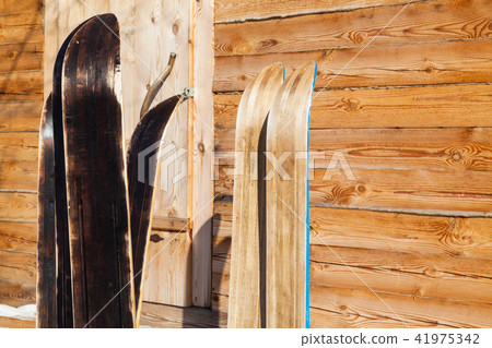 wide forest skis near wooden country house 41975342