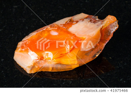 raw noble opal and fire opal gemstone on black 41975466