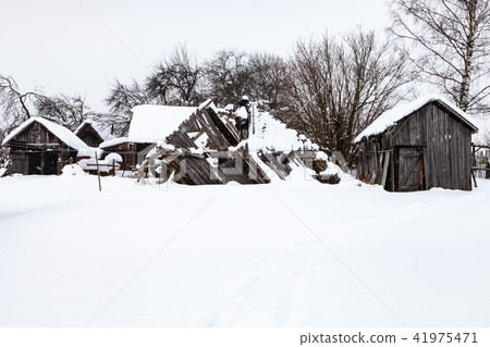 snow-covered old abandoned courtyard in village snow-covered old abandoned courtyard in village 41975471