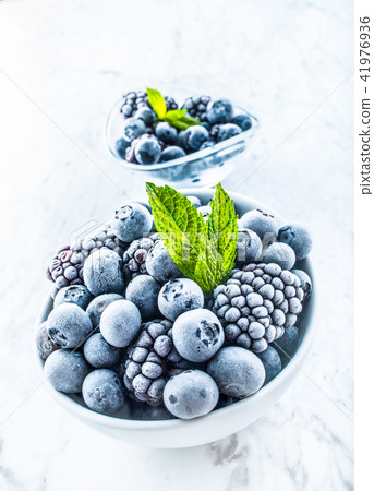 Frozen blueberries and blackberries with mint herb 41976936