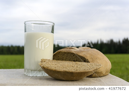 Milk and bread on a meadow Milk and bread on a meadow 41977672