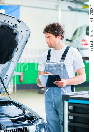 Car mechanic working with tool in service workshop 41978004