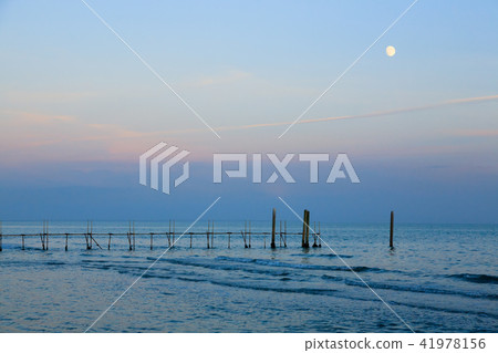 Beach landscape at dawn with moon Beach landscape at dawn with moon 41978156