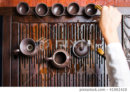 Female ordering tea cups during Chinese tea ceremony 41981428